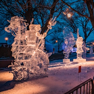 Ice sculptures illuminated with lights on display in the evening at Saint Paul Winter Carnival
